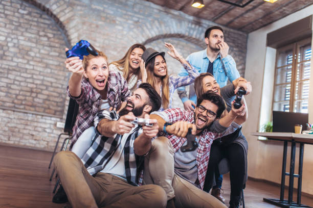 istock Coworkers playing video games in office 940235322