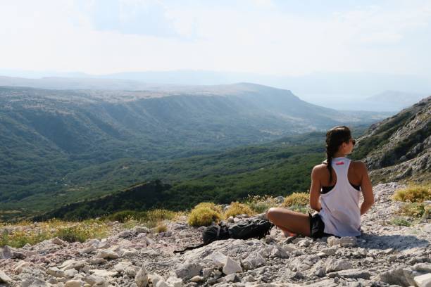 istock Young woman standing on the edge / cliffs / mountains 940236768
