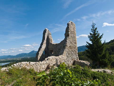 View of the ruins of the stone wall of medieval Samobor Castle on the hill Tepec with a clear blue sky in the background, Samobor, Croatia