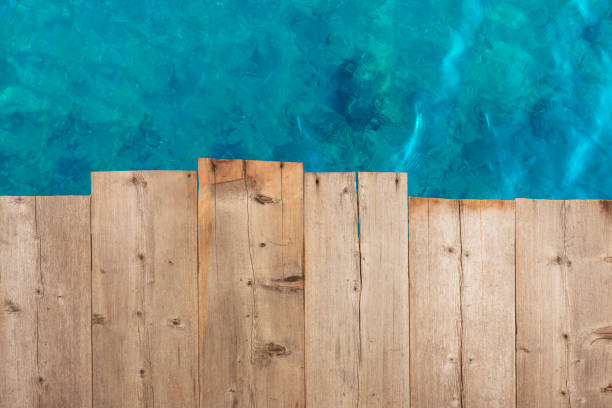 Wooden table top on blue sea and white sand beach