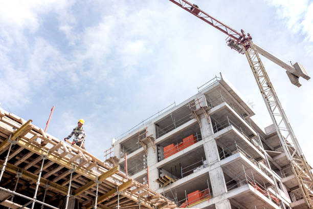 Construction Site View With Tower Crane A new building is being constructed with use of tower crane construction material stock pictures, royalty-free photos & images