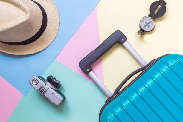 High angle view of summer vacation things on multicolored pastel background.