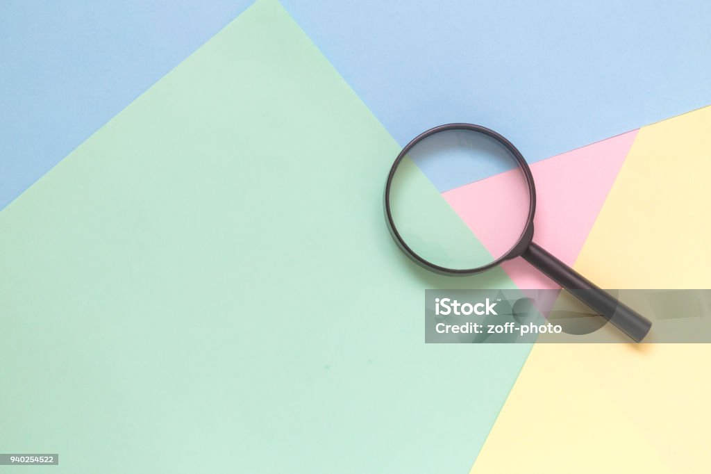 Lente di ingrandimento su sfondo pastello ricerca concetto minimalista. - Foto stock royalty-free di Lente d'ingrandimento