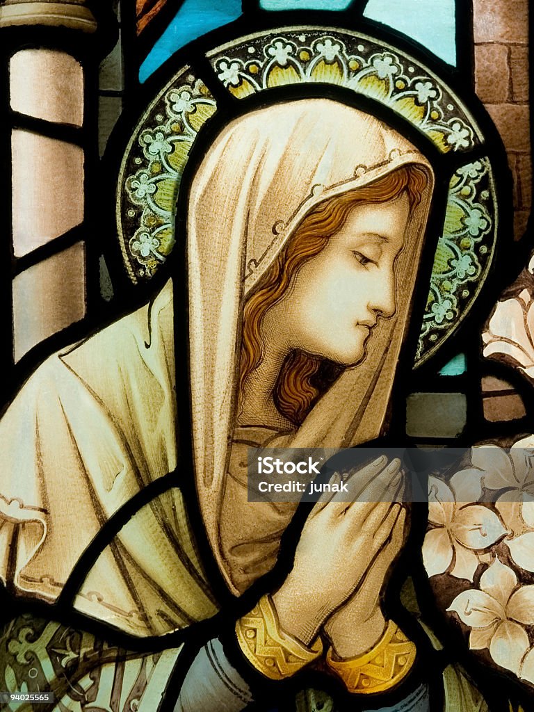 Stain glass window depiction of our lady Stained glass in Catholic church in Dublin showing Our Lady in deep prayer Virgin Mary Stock Photo