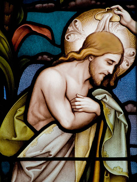 Religious stained glass window depicting a baptism Stained glass in Catholic church in Dublin showing baptism of Jesus baptism stock pictures, royalty-free photos & images