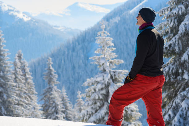istock Adventurer is standing in the winter mountains 940259924