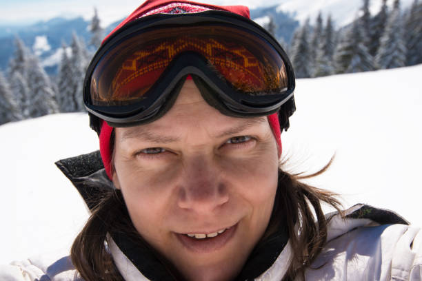 istock Joyful adventurer, woman in goggles taking selfie 940259976
