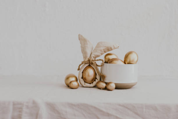 Still Life Happy Easter Background. Gold eggs and linen napkin with decorations