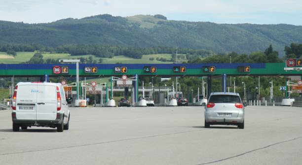 Vehicles approaching French autoroute toll booth stock photo