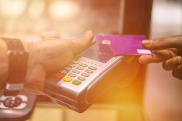 istock Woman paying with a credit card. 940267886
