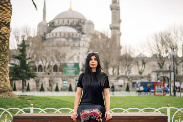 istock women sit near mosque 940268062