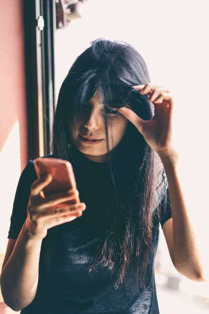 istock young women use mobil phone 940268812
