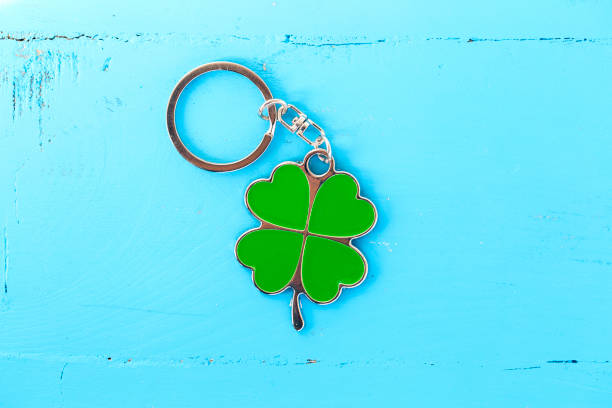 istock four-leaf clover green key chain with blue wooden background 940271464