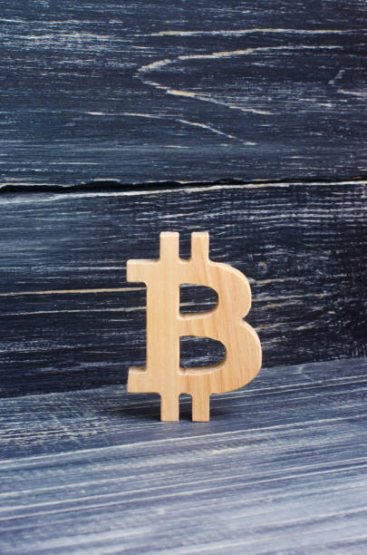 istock Wooden Bitcoin on a background of black boards. Crypto currency, blocking technology. The collapse and rise in the cost of bitcoin. Mining farms, miners, stock exchange crypts. Decentralized money. 940271766