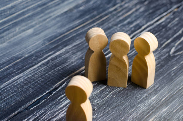 istock Three people meet one. Three people are aggressively attuned to one. People conduct an interview and a meeting. The concept of attack, threats, encounters, education. Businessmen stand in a group of three. 940271918
