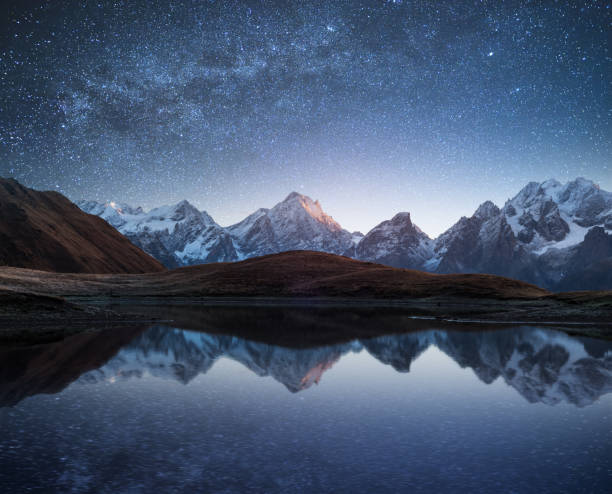 istock Night landscape with a mountain lake and a starry sky 940272306