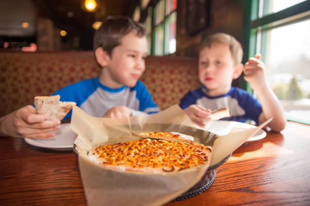 children eat unhealthy food indoors. selective focus