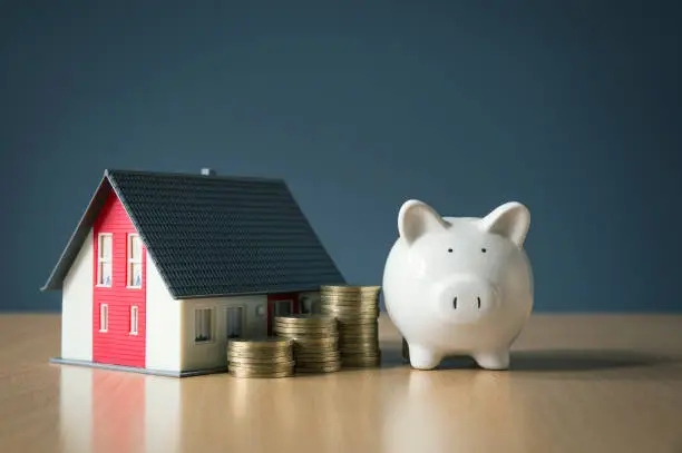 Photo of Saving money for house concept with white piggy bank