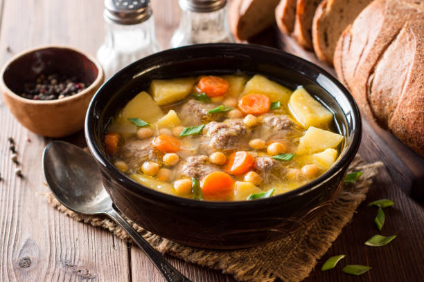 istock Soup with meatballs, vegetables and chickpea on wooden table 940283466