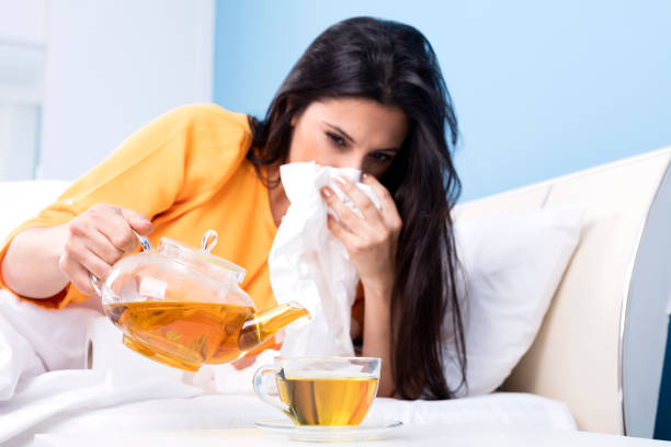 istock flu woman is drinking herbal tea on bed 940283706