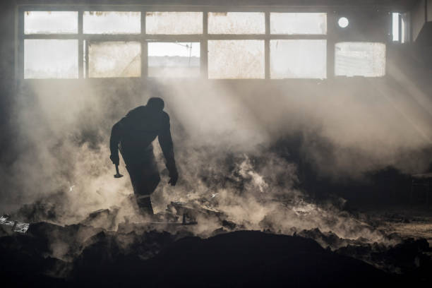 worker silhouette with his hammer a foundry worker silhouette with his hammer in foggy background factory worker silhouette stock pictures, royalty-free photos & images