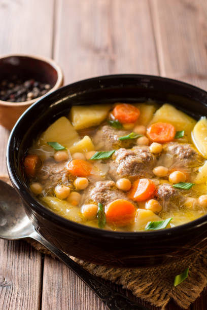 istock Soup with meatballs, vegetables and chickpea on wooden table 940283834