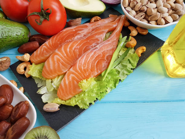 istock red fish, avocado on blue wooden 940287808