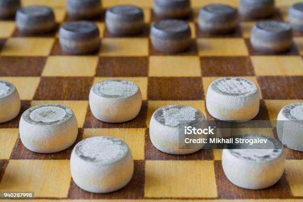 Fragment Of Wooden Checkerboard With Checkers Spaced On Table Stock Photo - Download Image Now