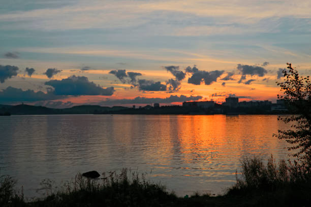 istock Summer landscape on the shore of a pond 940296378