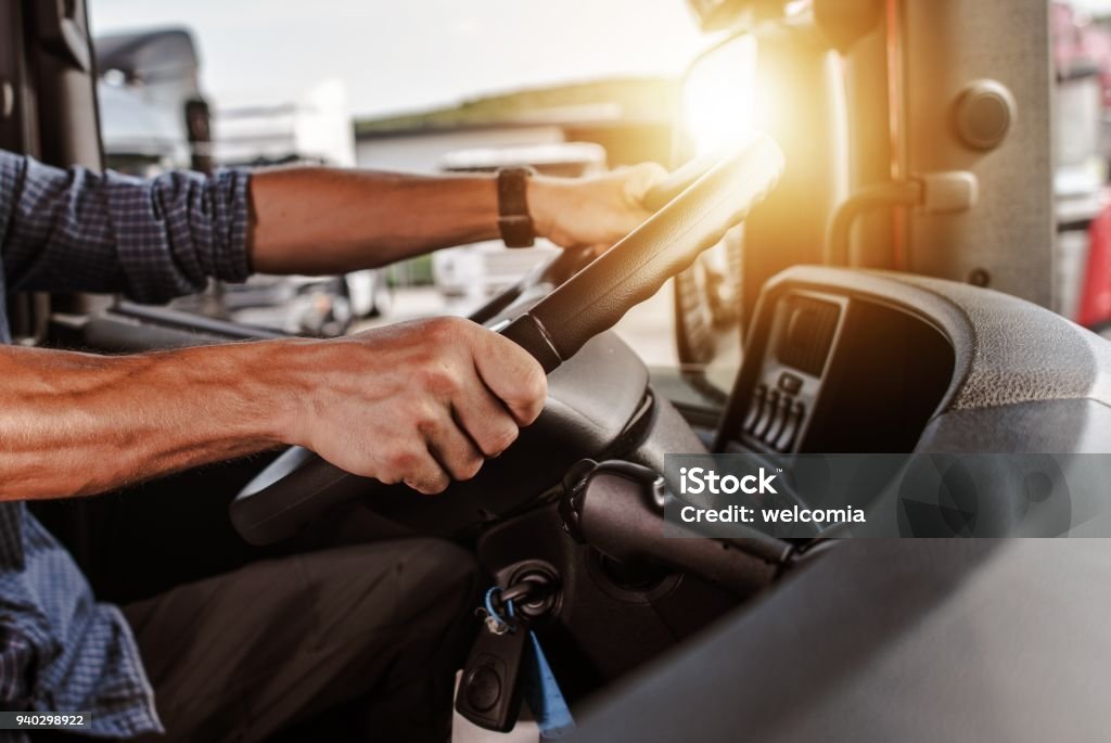 CDL Commercial Driver CDL Commercial Driver Inside of His Truck. Transportation Industry Theme. Driving Stock Photo