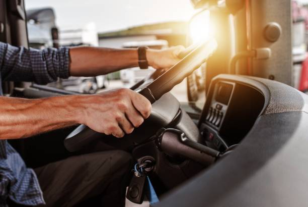 CDL Commercial Driver CDL Commercial Driver Inside of His Truck. Transportation Industry Theme. passenger cabin photos stock pictures, royalty-free photos & images