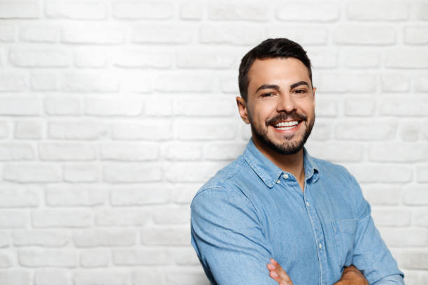 istock Facial Expressions Of Young Beard Man On Brick Wall 940299848