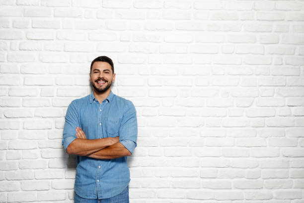 istock Facial Expressions Of Young Beard Man On Brick Wall 940299876