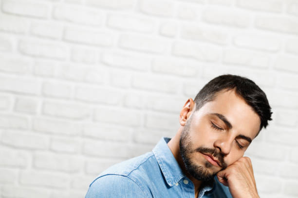 istock Facial Expressions Of Young Beard Man On Brick Wall 940299906