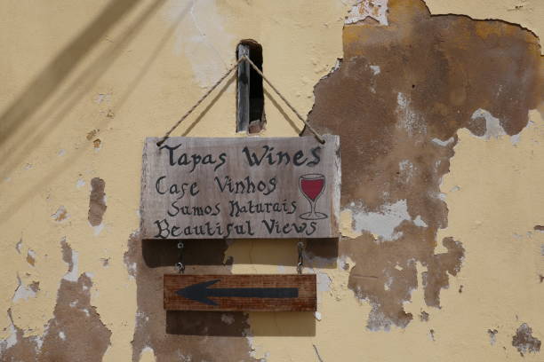 istock Sign post . Weathered blackboard with hand writing informations for a cafe or a bar with wine, other drinks, food and beautiful view 940299990