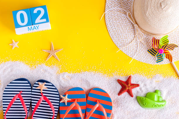 istock May 2nd. Image of may 2 calendar with summer beach accessories. Spring like Summer vacation concept 940303462