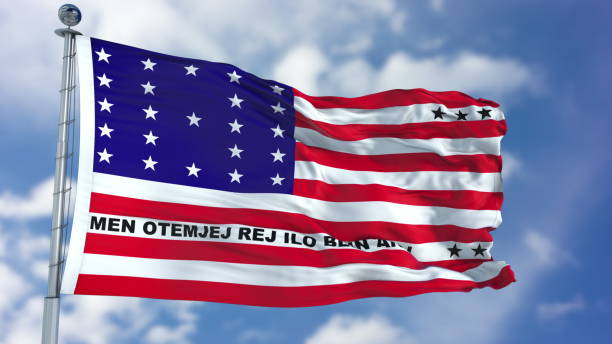 istock Bikini Atoll Flag in a Blue Sky 940318172