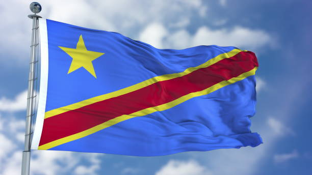 bandiera della repubblica democratica del congo in un cielo blu - congolese flag foto e immagini stock