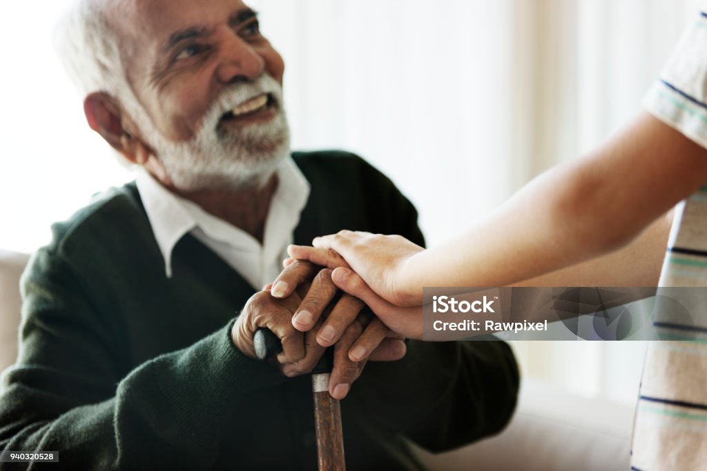 Grandson holding grandpa's hands Senior Adult Stock Photo