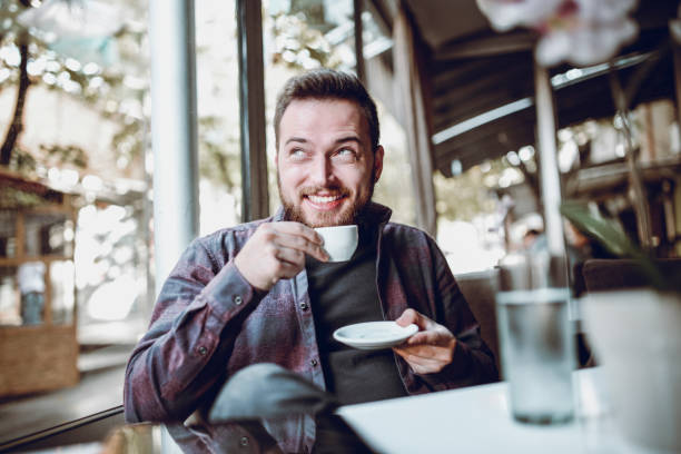 istock Young Smiling Man at Home with First Coffee in the Morning 940320724