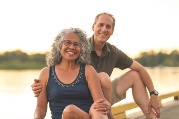 istock Senior Couple Enjoying a River Sunset on the Dock 940320856