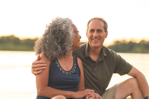 istock Senior Couple Enjoying a River Sunset on the Dock 940320878