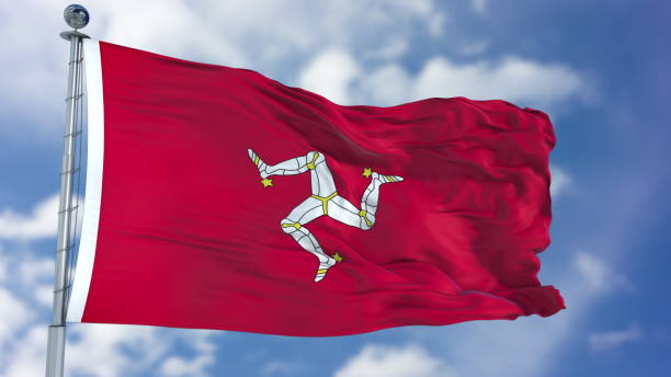 istock Isle of Man Flag in a Blue Sky 940321774