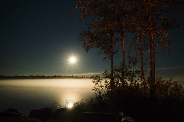 Moonlight Moon over the lake in Finnish Lapland. finnish lapland autumn stock pictures, royalty-free photos & images