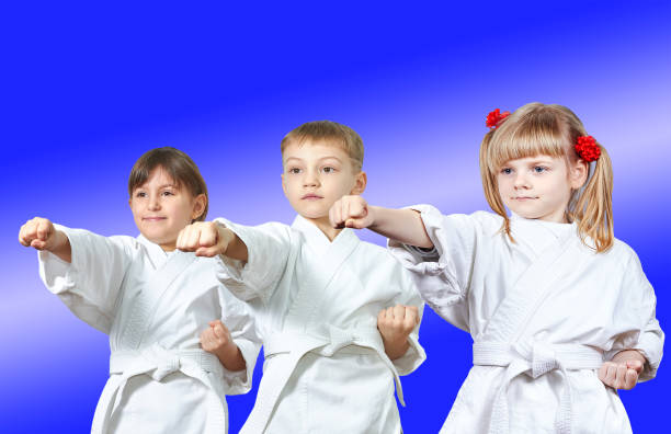 istock Kids in karategi are hitting punch arm 940327274