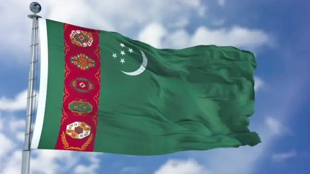 Photo of Turkmenistan Flag in a Blue Sky