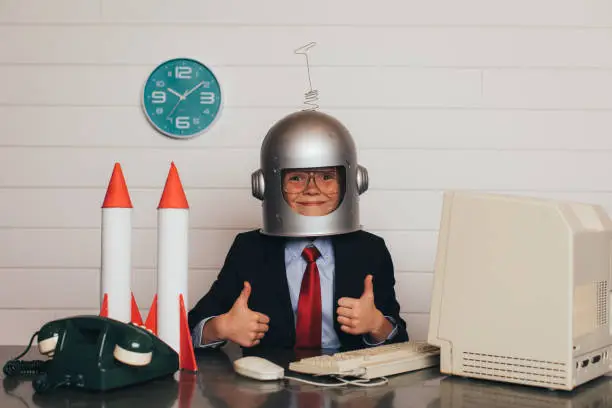 Photo of Young Business Boy with Space Helmet and Rockets