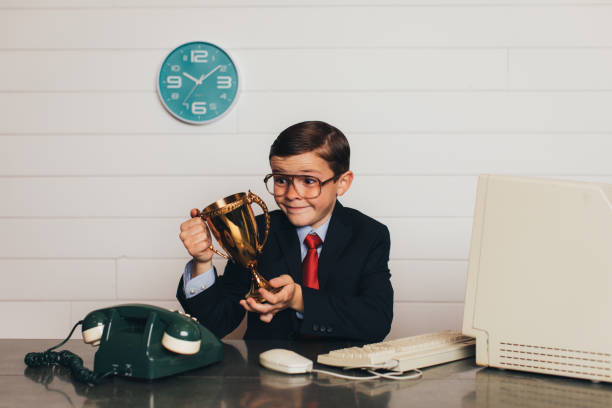 istock Young Retro Business Boy in Office with Trophy 940334474