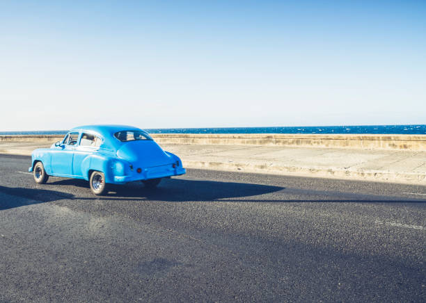 istock Vintage car driving along coast,Malecon 940338130