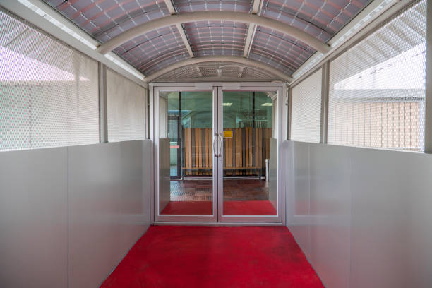 Glass doors and red carpet in the daytime.
